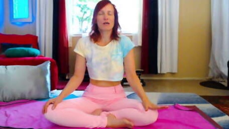 Aurora Willows stretching in pink pants and crop top
