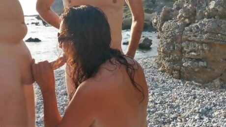 Hotwife gives blowjobs to guys at the beach